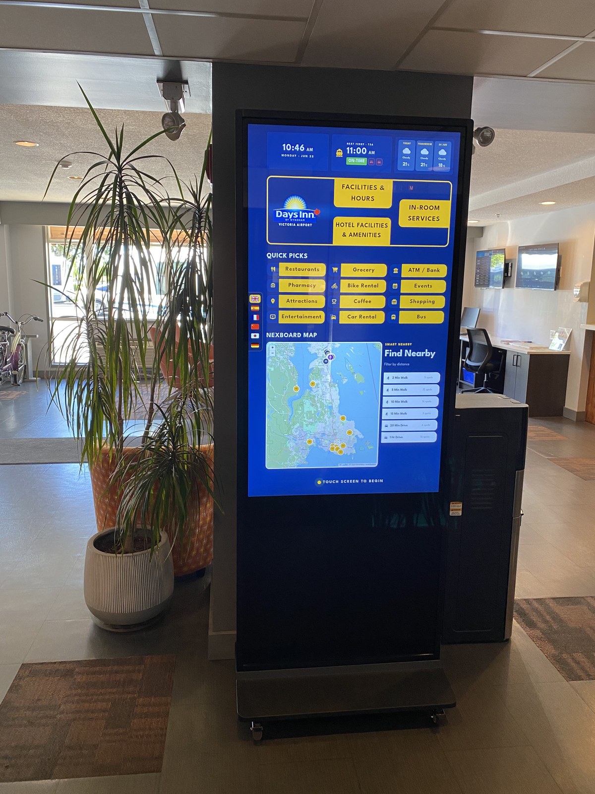NexBoards touchscreen showing the Days Inn Victoria Airport guide in the hotel lobby